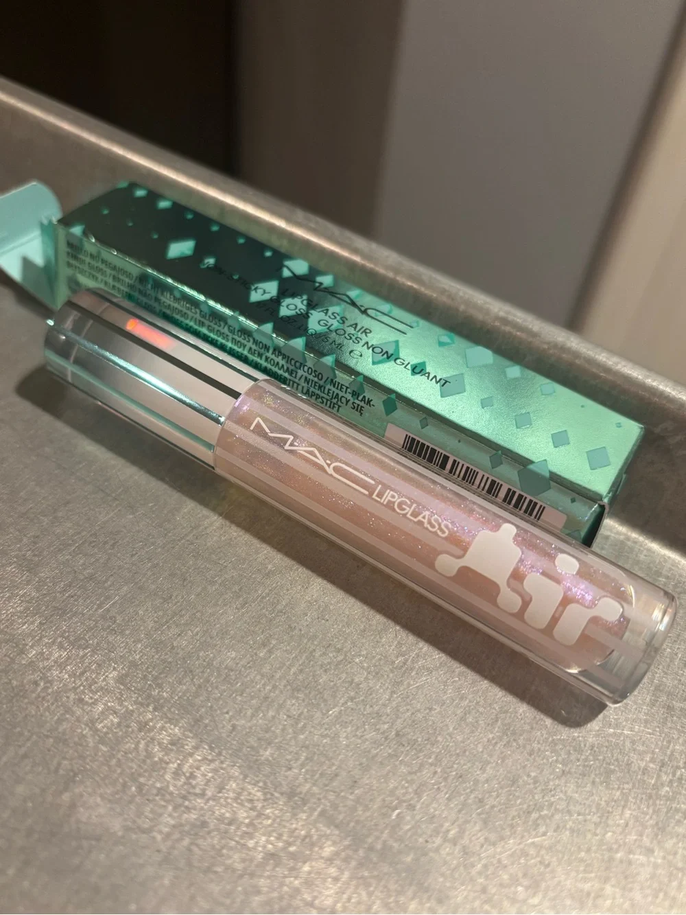 MAC Cosmetics Lipglass Gloss in shade Frozen a shimmery pink w blue reflect